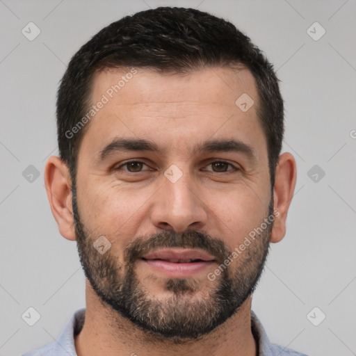 Joyful white young-adult male with short  black hair and brown eyes