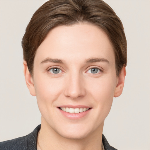 Joyful white young-adult female with short  brown hair and grey eyes