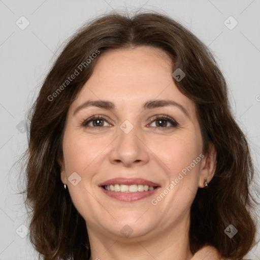 Joyful white adult female with long  brown hair and brown eyes