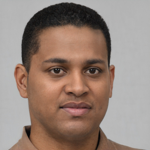 Joyful latino young-adult male with short  brown hair and brown eyes