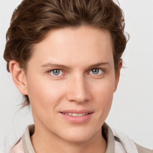 Joyful white young-adult female with medium  brown hair and blue eyes