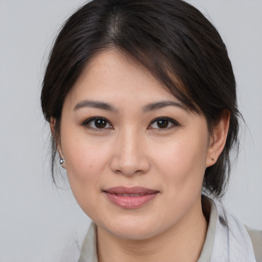 Joyful white young-adult female with medium  brown hair and brown eyes