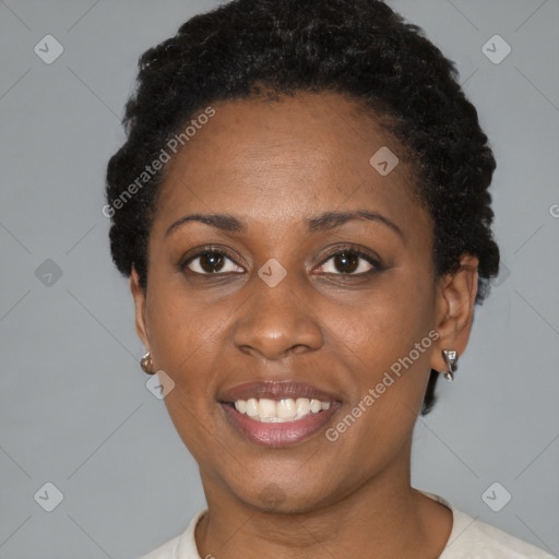 Joyful black young-adult female with short  black hair and brown eyes