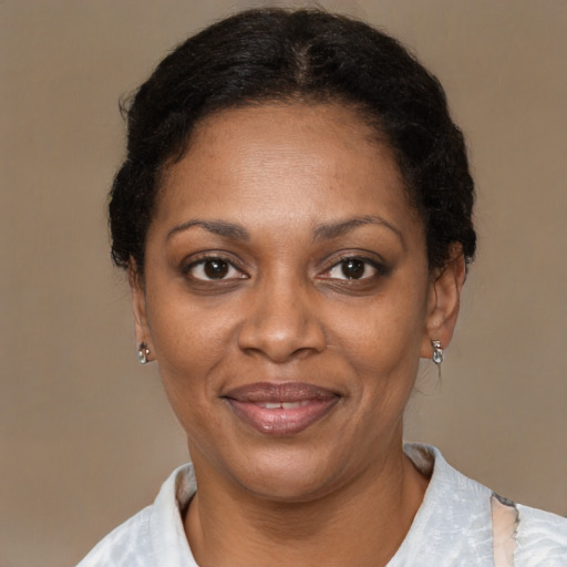 Joyful black adult female with short  brown hair and brown eyes