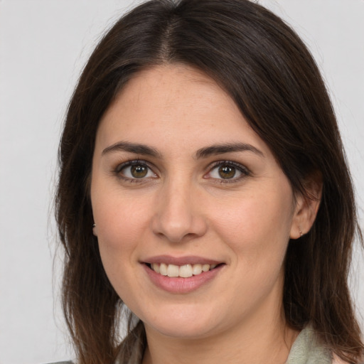 Joyful white young-adult female with long  brown hair and brown eyes