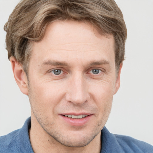 Joyful white adult male with short  brown hair and grey eyes