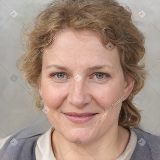 Joyful white adult female with medium  brown hair and blue eyes