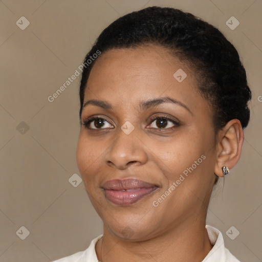 Joyful black adult female with short  black hair and brown eyes