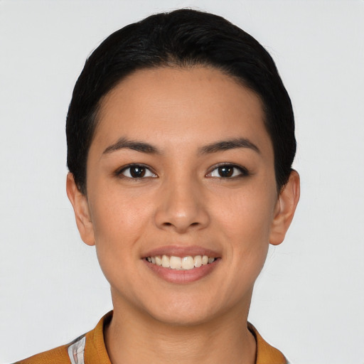 Joyful latino young-adult female with short  black hair and brown eyes