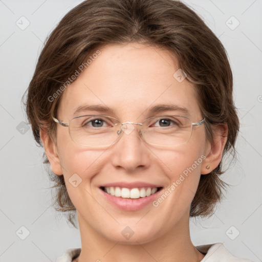 Joyful white adult female with medium  brown hair and grey eyes