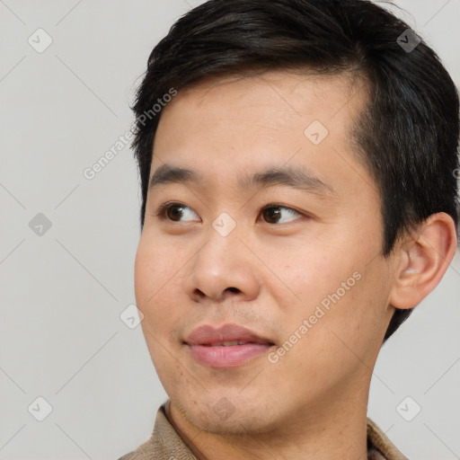 Joyful white young-adult male with short  black hair and brown eyes