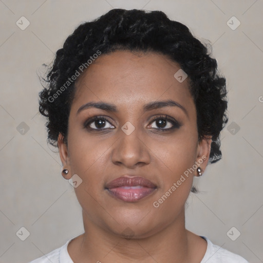 Joyful black young-adult female with short  black hair and brown eyes