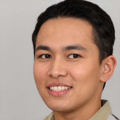 Joyful asian young-adult male with short  black hair and brown eyes