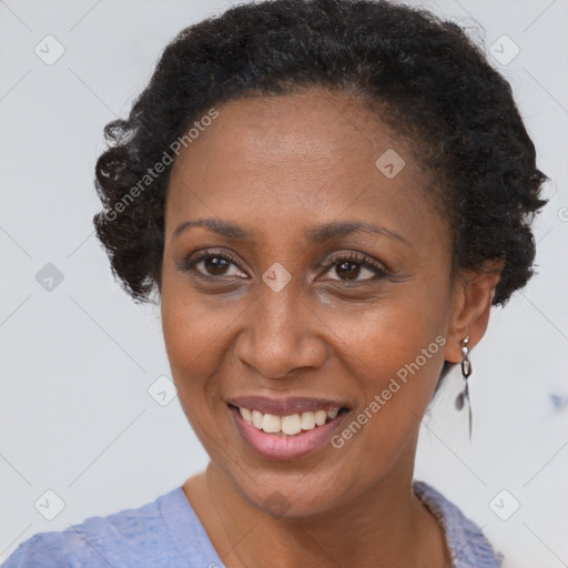 Joyful black adult female with short  brown hair and brown eyes