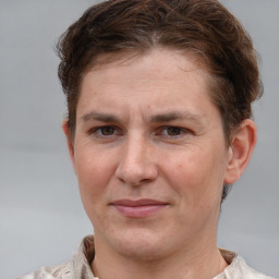 Joyful white adult female with short  brown hair and grey eyes