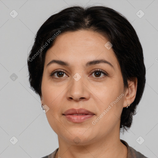 Joyful latino adult female with medium  brown hair and brown eyes