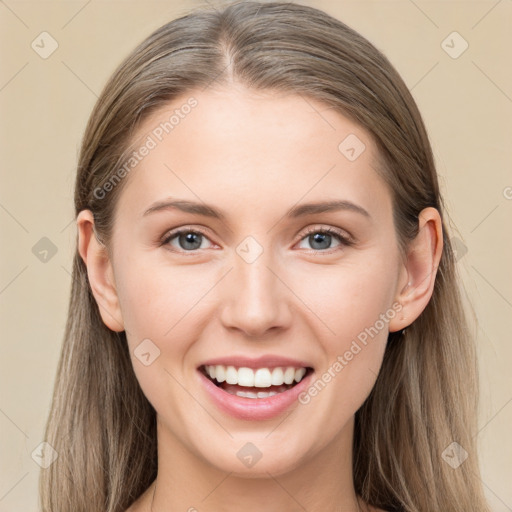 Joyful white young-adult female with long  brown hair and grey eyes