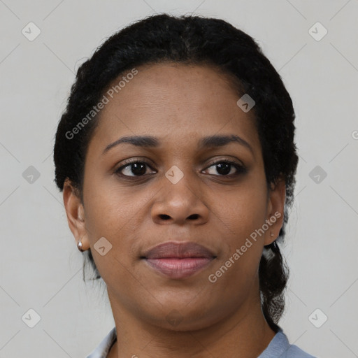 Joyful black young-adult female with short  black hair and brown eyes