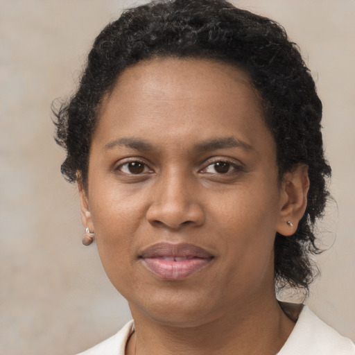 Joyful black adult female with short  brown hair and brown eyes
