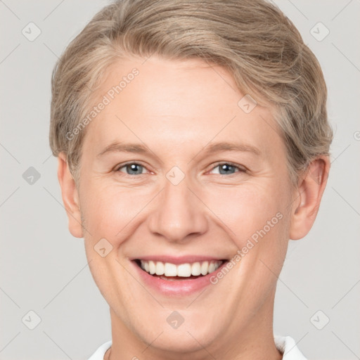 Joyful white young-adult female with short  brown hair and grey eyes