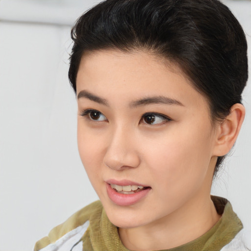 Joyful asian young-adult female with medium  brown hair and brown eyes