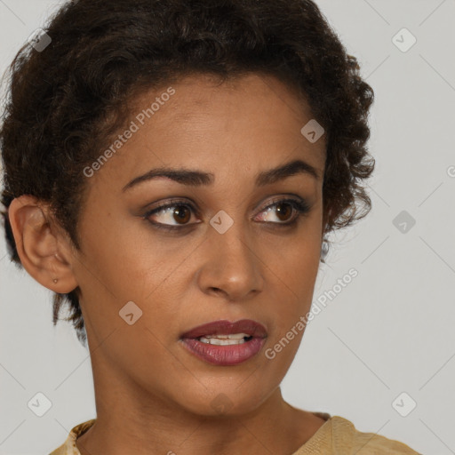 Joyful black young-adult female with short  brown hair and brown eyes