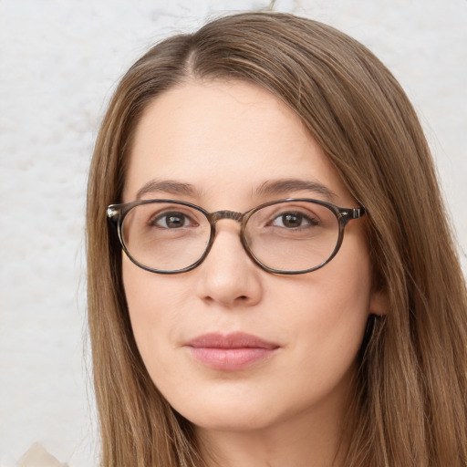 Joyful white young-adult female with long  brown hair and green eyes