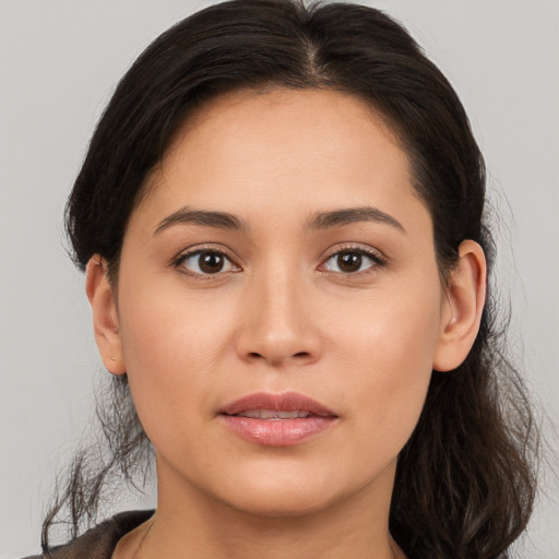 Joyful white young-adult female with long  brown hair and brown eyes