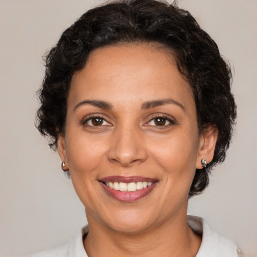 Joyful latino adult female with short  brown hair and brown eyes