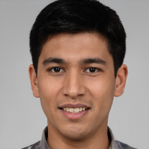 Joyful white young-adult male with short  black hair and brown eyes