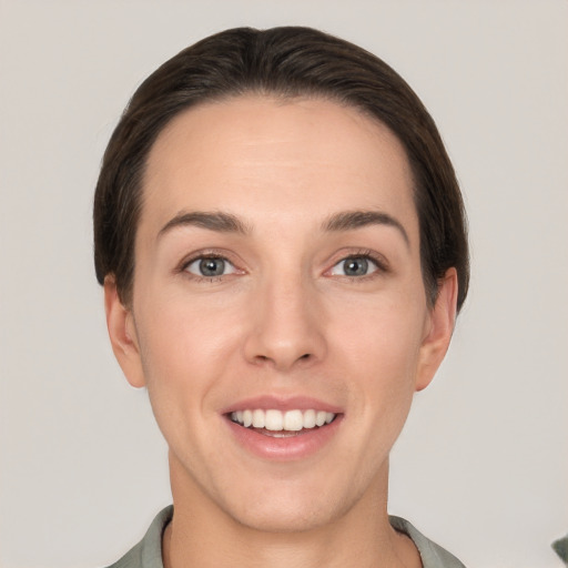 Joyful white young-adult female with short  brown hair and grey eyes