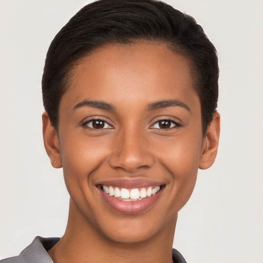 Joyful latino young-adult female with short  brown hair and brown eyes