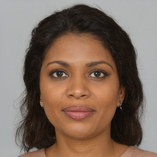 Joyful black young-adult female with medium  brown hair and brown eyes