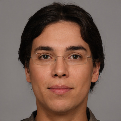 Joyful white adult male with medium  brown hair and brown eyes