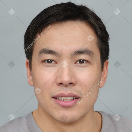 Joyful asian young-adult male with short  brown hair and brown eyes