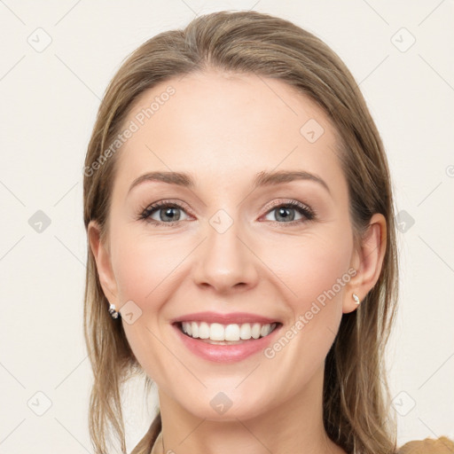 Joyful white young-adult female with long  brown hair and grey eyes