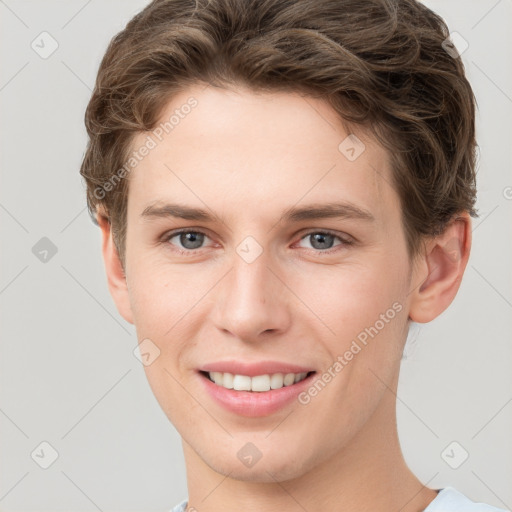 Joyful white young-adult female with short  brown hair and grey eyes