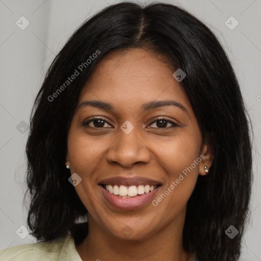 Joyful black young-adult female with long  black hair and brown eyes