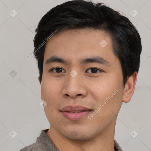 Joyful asian young-adult male with short  black hair and brown eyes