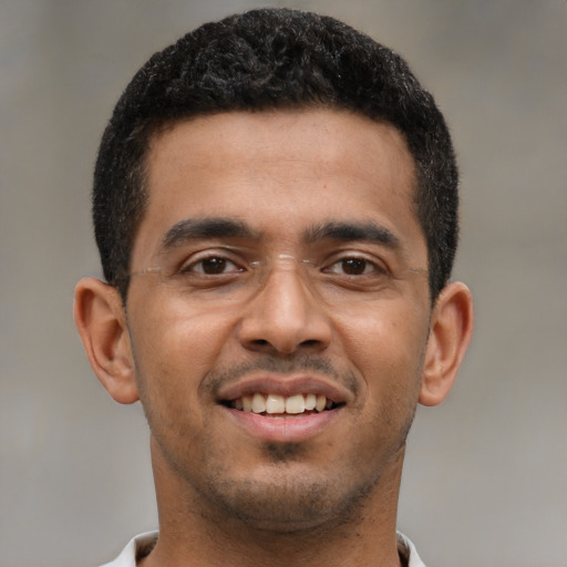 Joyful latino young-adult male with short  black hair and brown eyes