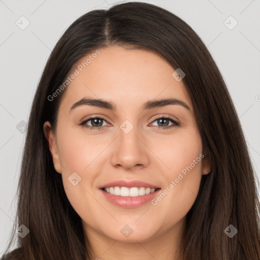 Joyful white young-adult female with long  brown hair and brown eyes