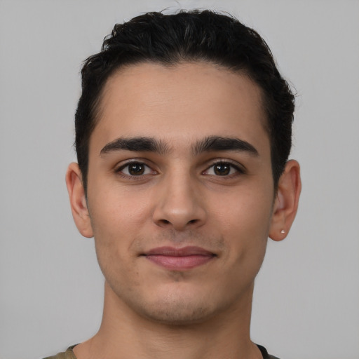 Joyful latino young-adult male with short  brown hair and brown eyes