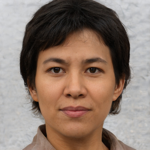 Joyful asian adult female with short  brown hair and brown eyes