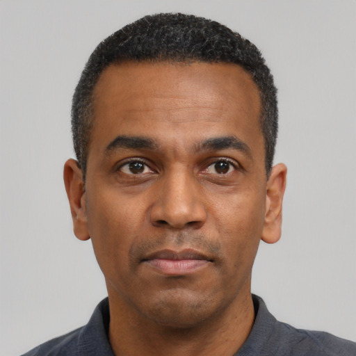 Neutral latino adult male with short  black hair and brown eyes