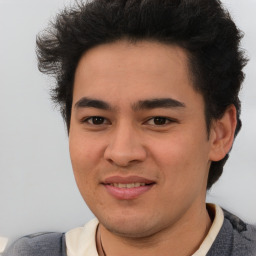 Joyful latino young-adult male with short  brown hair and brown eyes