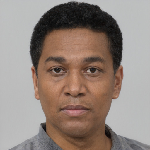 Neutral latino adult male with short  black hair and brown eyes