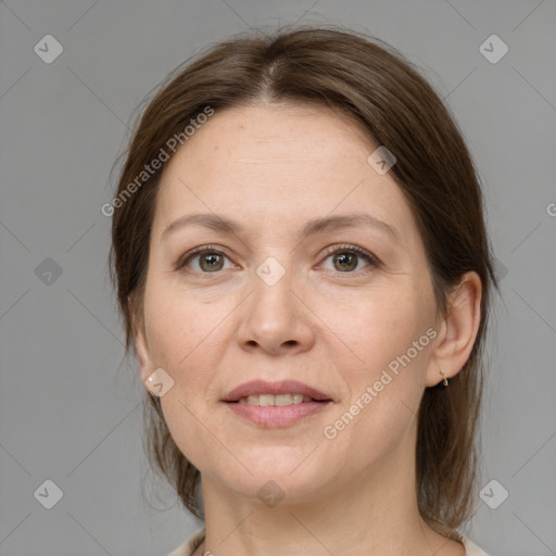 Joyful white adult female with medium  brown hair and grey eyes