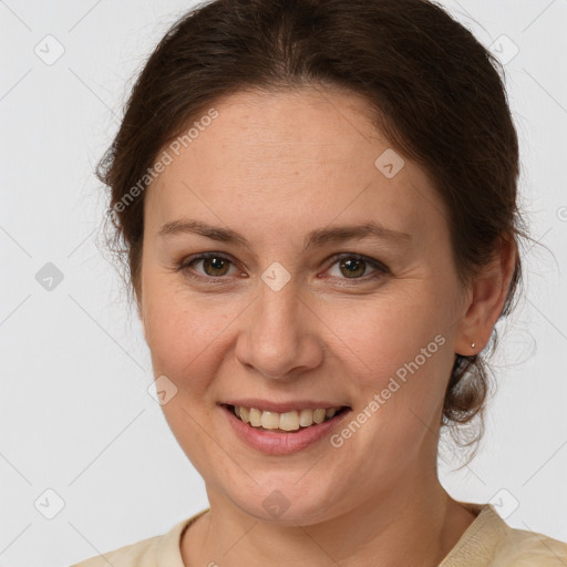 Joyful white adult female with medium  brown hair and brown eyes