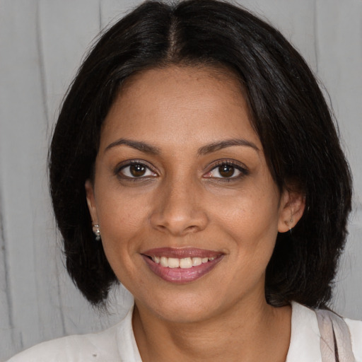 Joyful black young-adult female with medium  brown hair and brown eyes