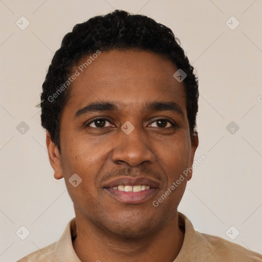 Joyful black young-adult male with short  black hair and brown eyes